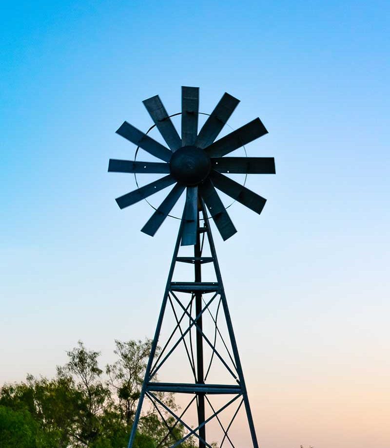 Windmill on a backroad at sunset